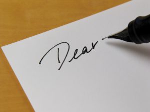 Pen writing "Dear"