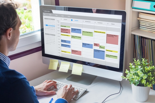 Sales leader looking at his daily schedule on his computer.